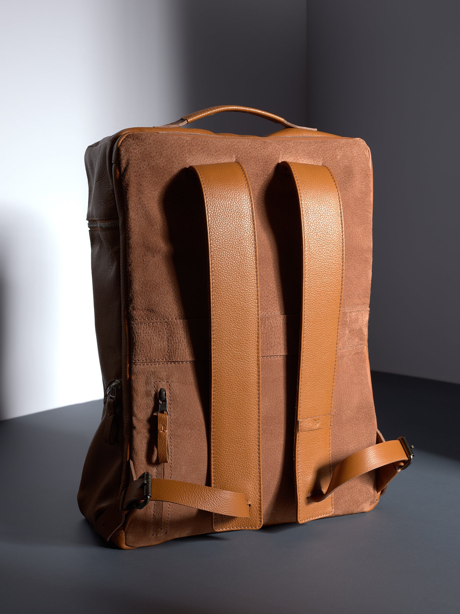 Back view of the Capra Banteng leather backpack, highlighting the comfortable straps and suede back panel.