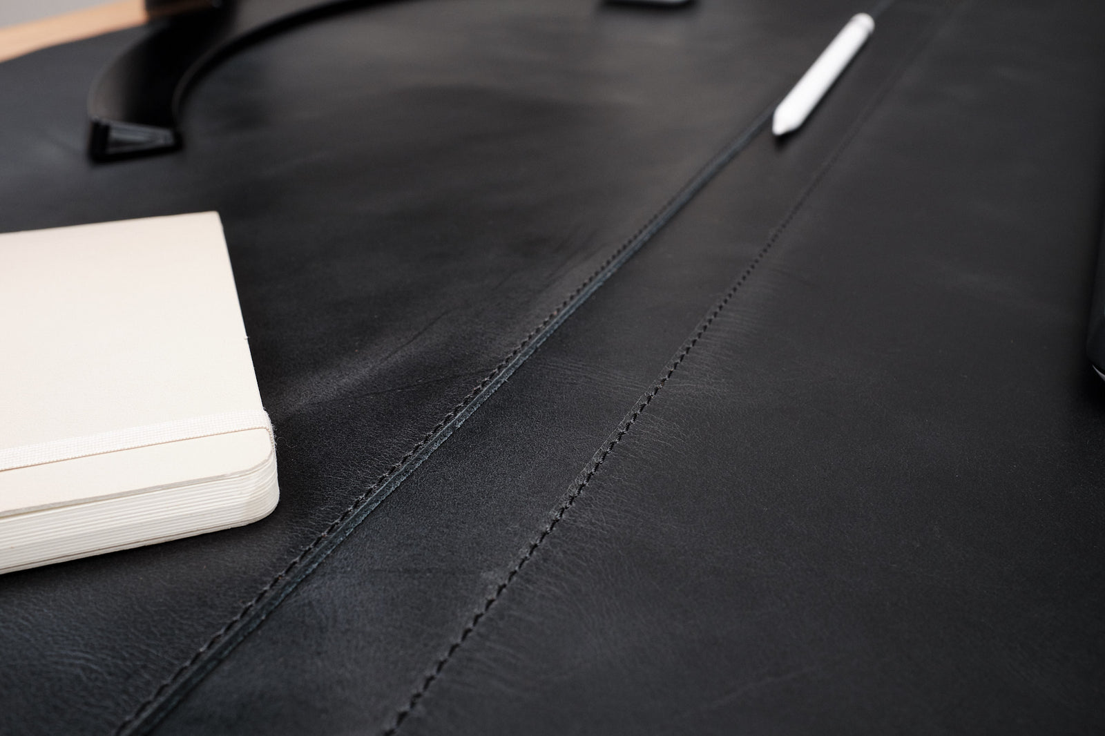 Leather desk pad featuring an optional pen slot.