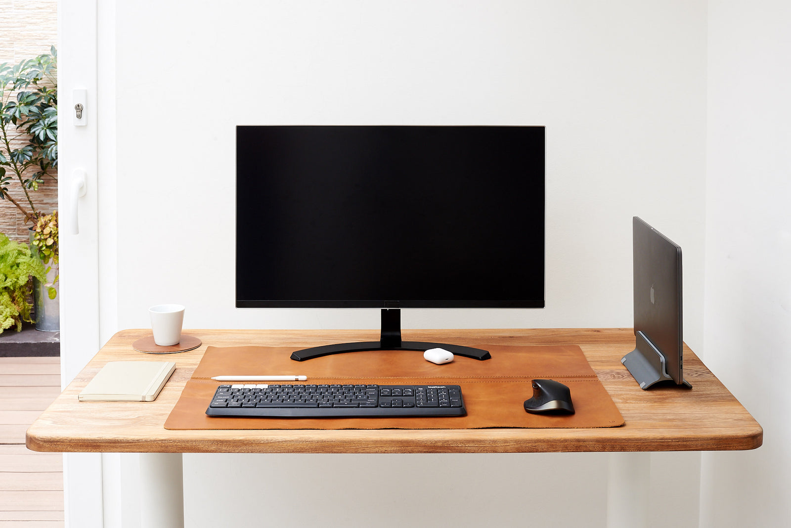 Smooth leather desk pad for a sophisticated setup.