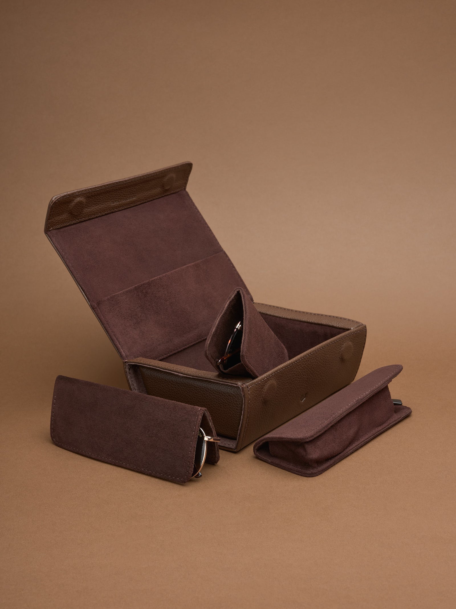 Capra Leather brown multiple sunglasses travel case, open with one sunglass pouch displayed.