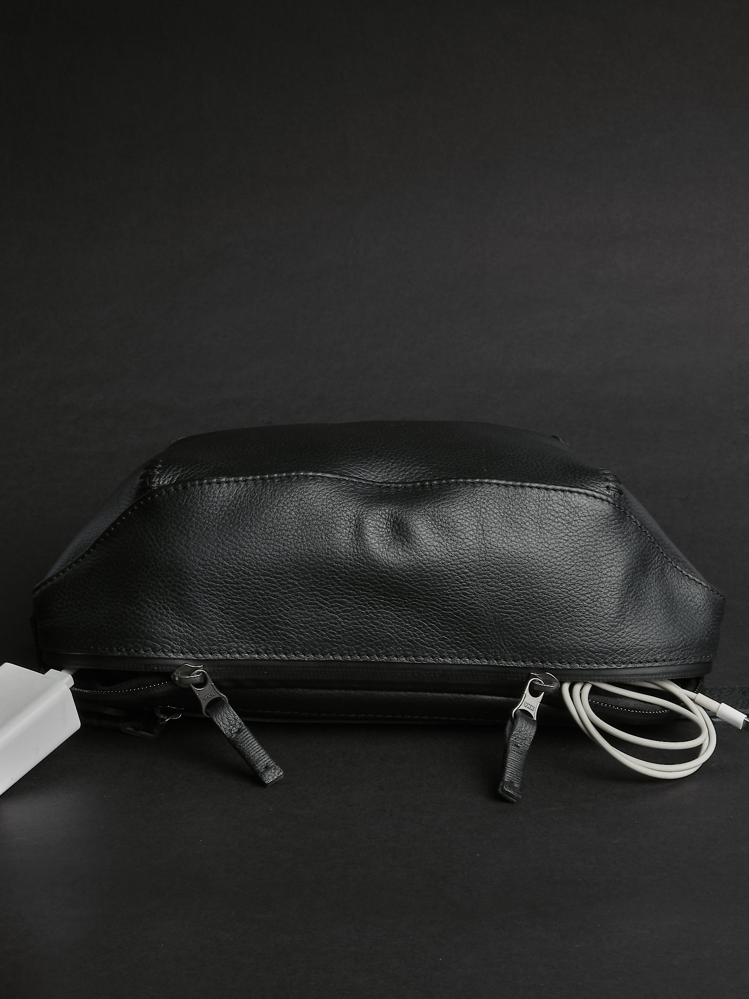 Kissing water-resistant zippers. Small Sling Bag Black by Capra Leather