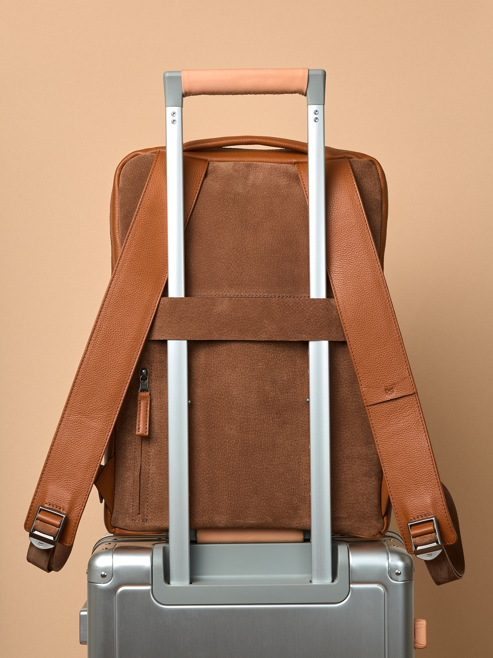 Suede and leather backpack made for men. Soft finish in leather. Invisible luggage strap for easy travel on plane. Comfortable and soft feeling. Premium materials. Made in leather by Capra Leather.