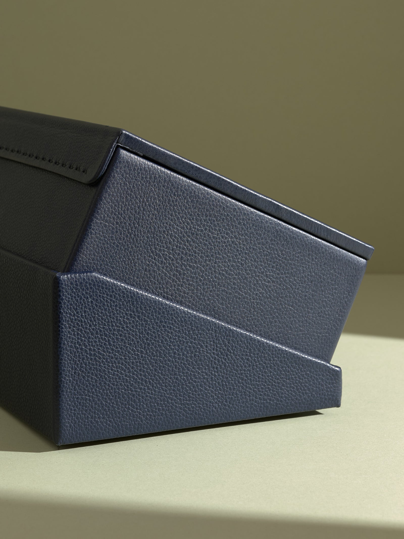 The Podium profile showing the layered design of the Capra leather watch box and storage drawer stand.