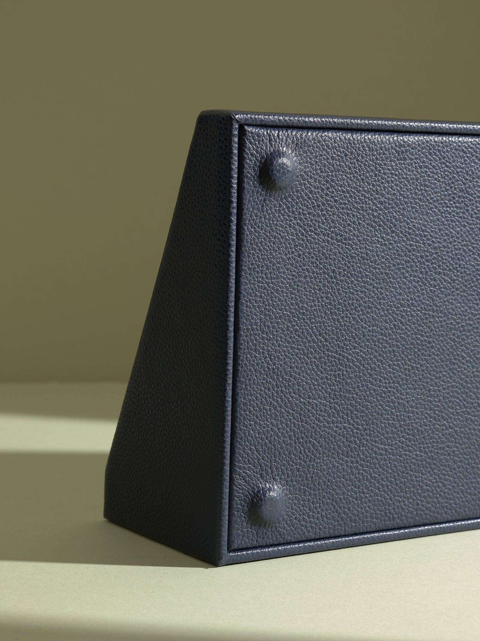 The Podium Corner close-up of the base of the Capra leather watch box with its signature protective feet.