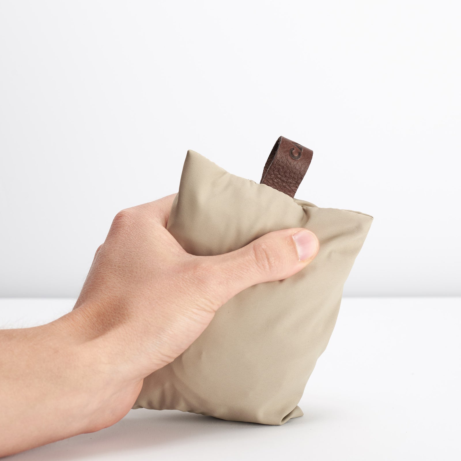 Style Beige Perfect fit for all Capra backpacks. Fashionable matte waterproof material. Leather details by Capra Leather.