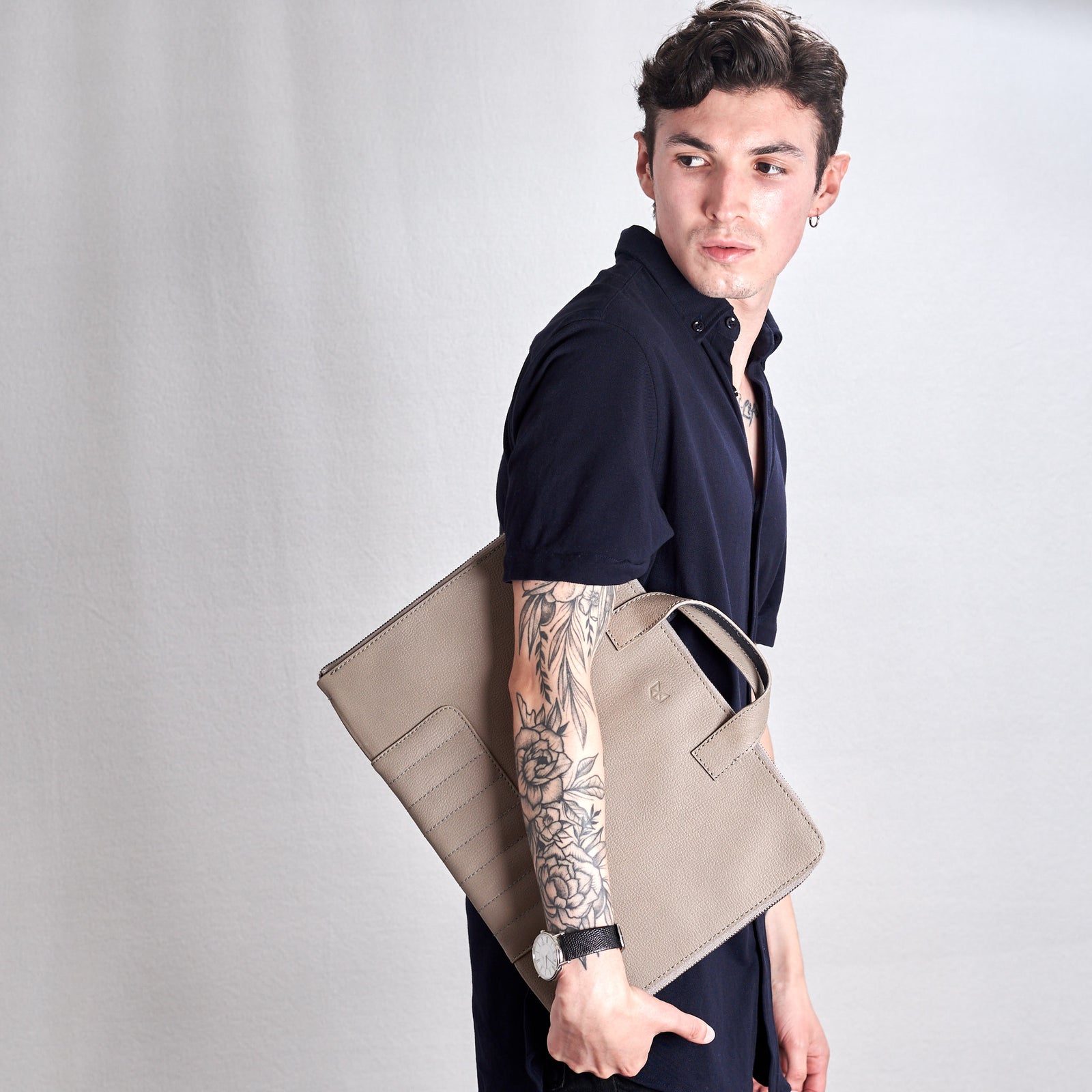 Style picture, hand holding Biker portfolio made by Capra Leather.