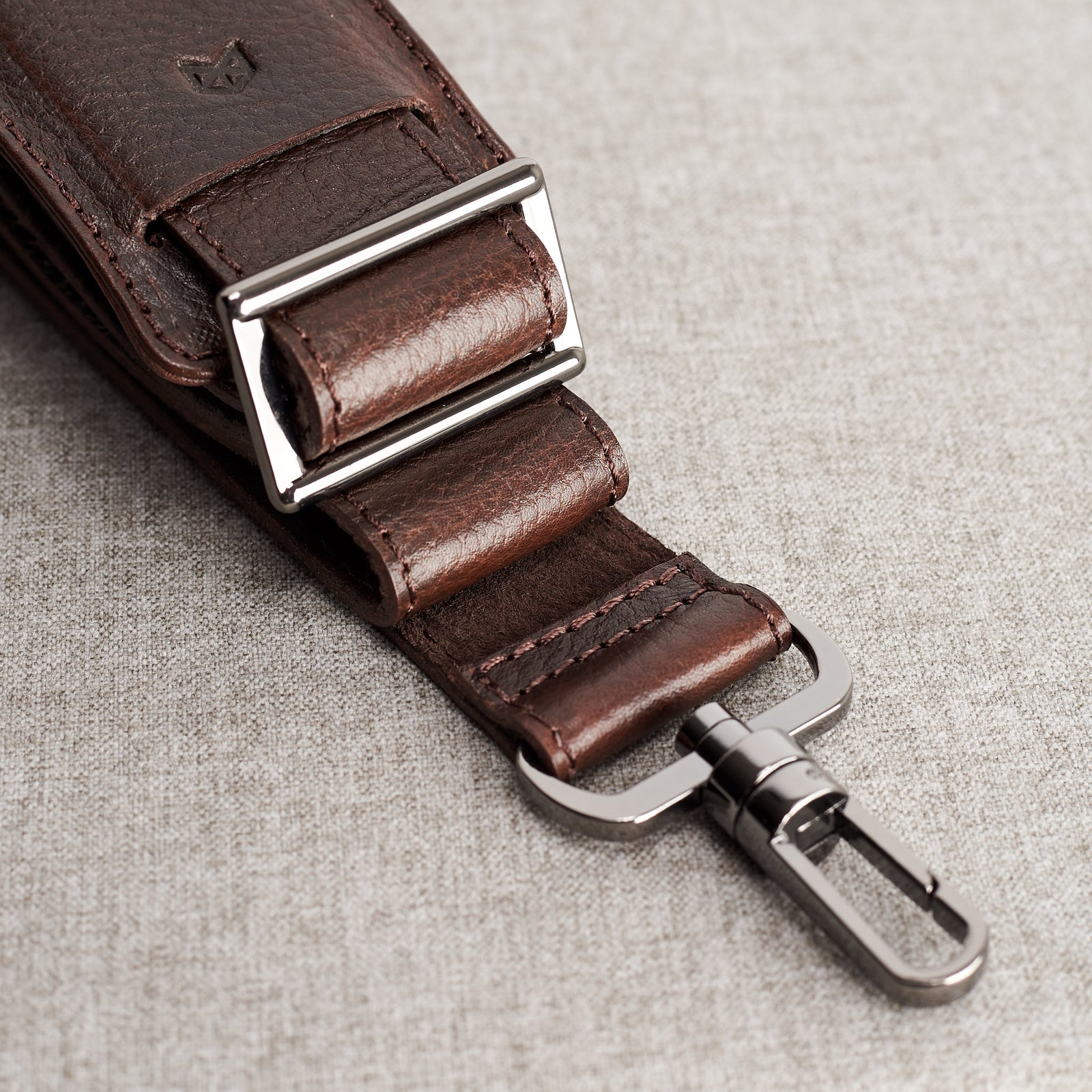 Suede texture close up from Shoulder strap. Dark brown leather soft briefcase. Office minimalist style bag