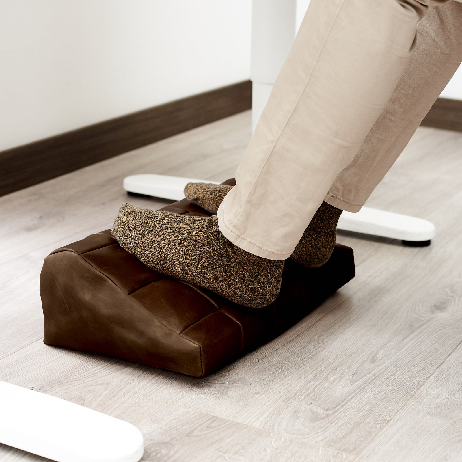 Cover. Ergonomic under desk footrest cover in brown by Capra Leather