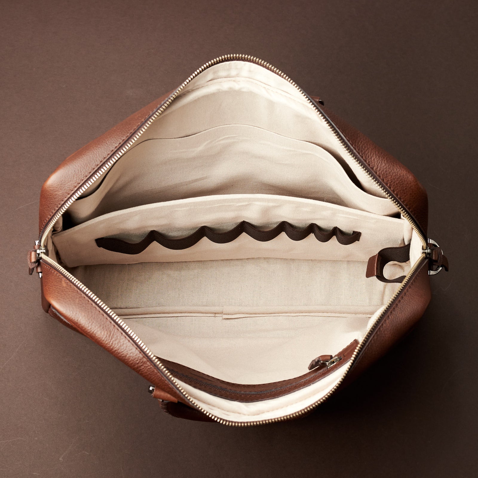 Interior with 7 division slots .Brown leather briefcase laptop bag for men. Gazeli laptop briefcase by Capra Leather.