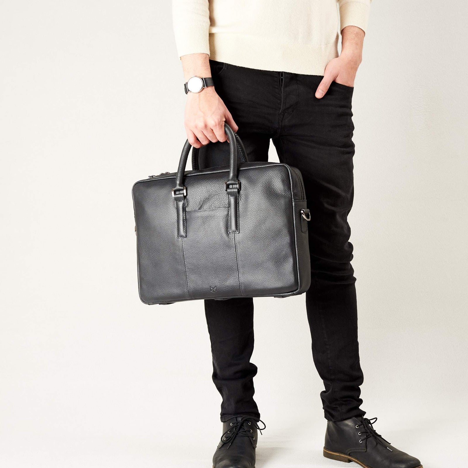 Style view, model holding bussiness document portfolio bag .Black leather briefcase laptop bag for men. Gazeli laptop briefcase by Capra Leather.