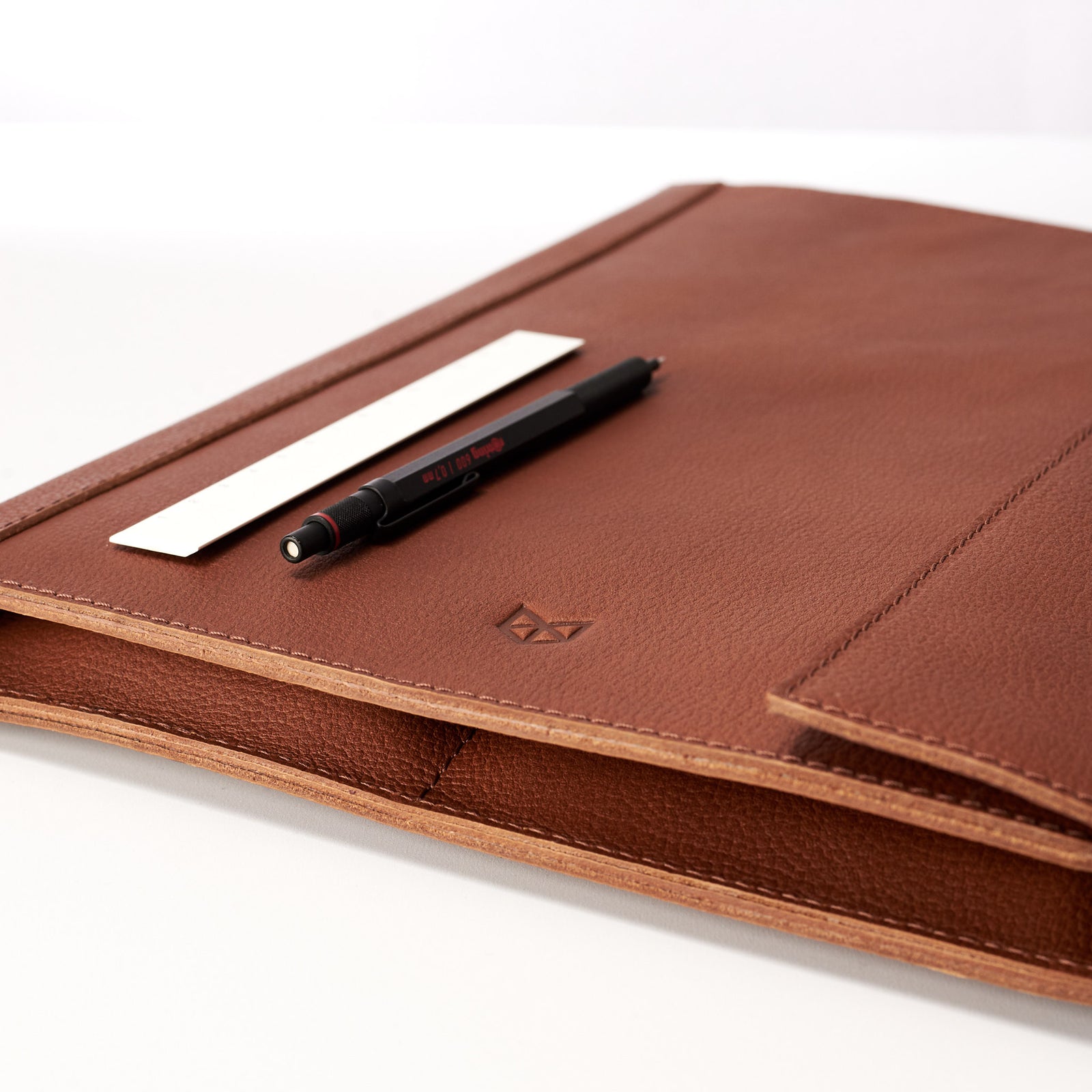 Logo detail. Tan Laptop Tablet Portfolio. Business Document Organizer for Men by Capra Leather