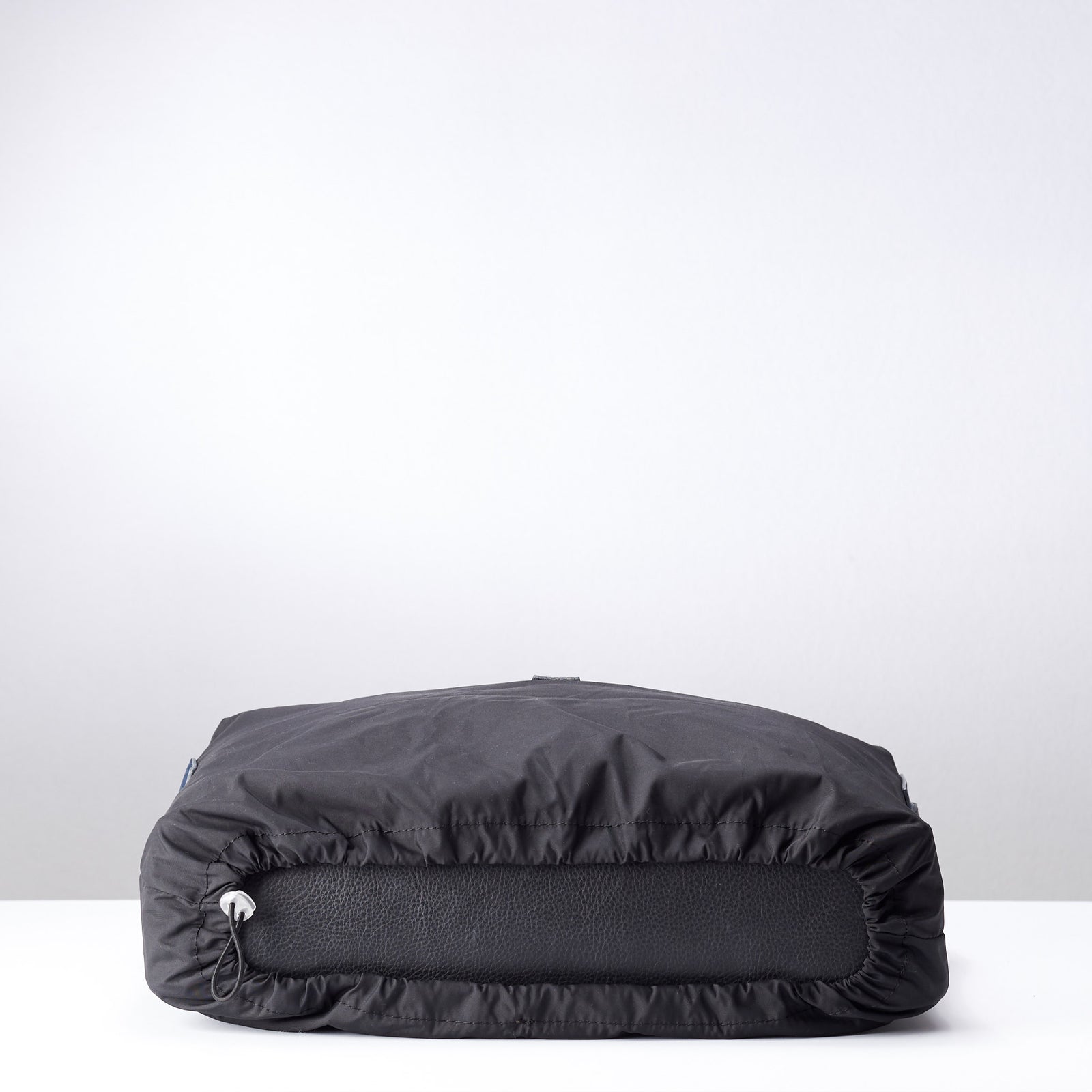 Wrap cinch. Black rain cover protection messenger bags. Fashionable matte waterproof material. Leather details by Capra Leather.