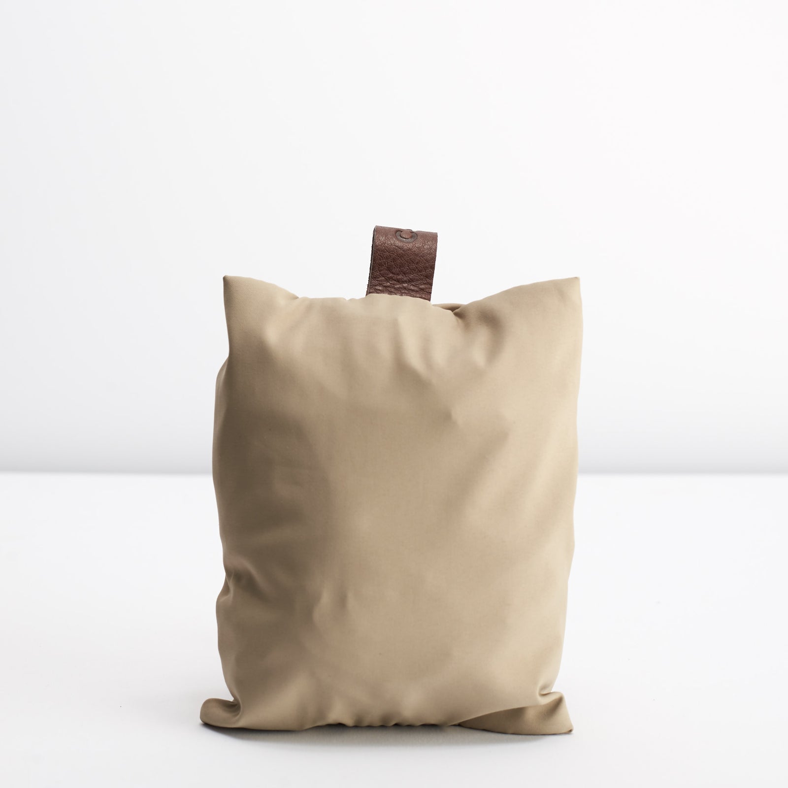 Attached carrying case. Beige waterproof rain cover for Capra leather backpacks