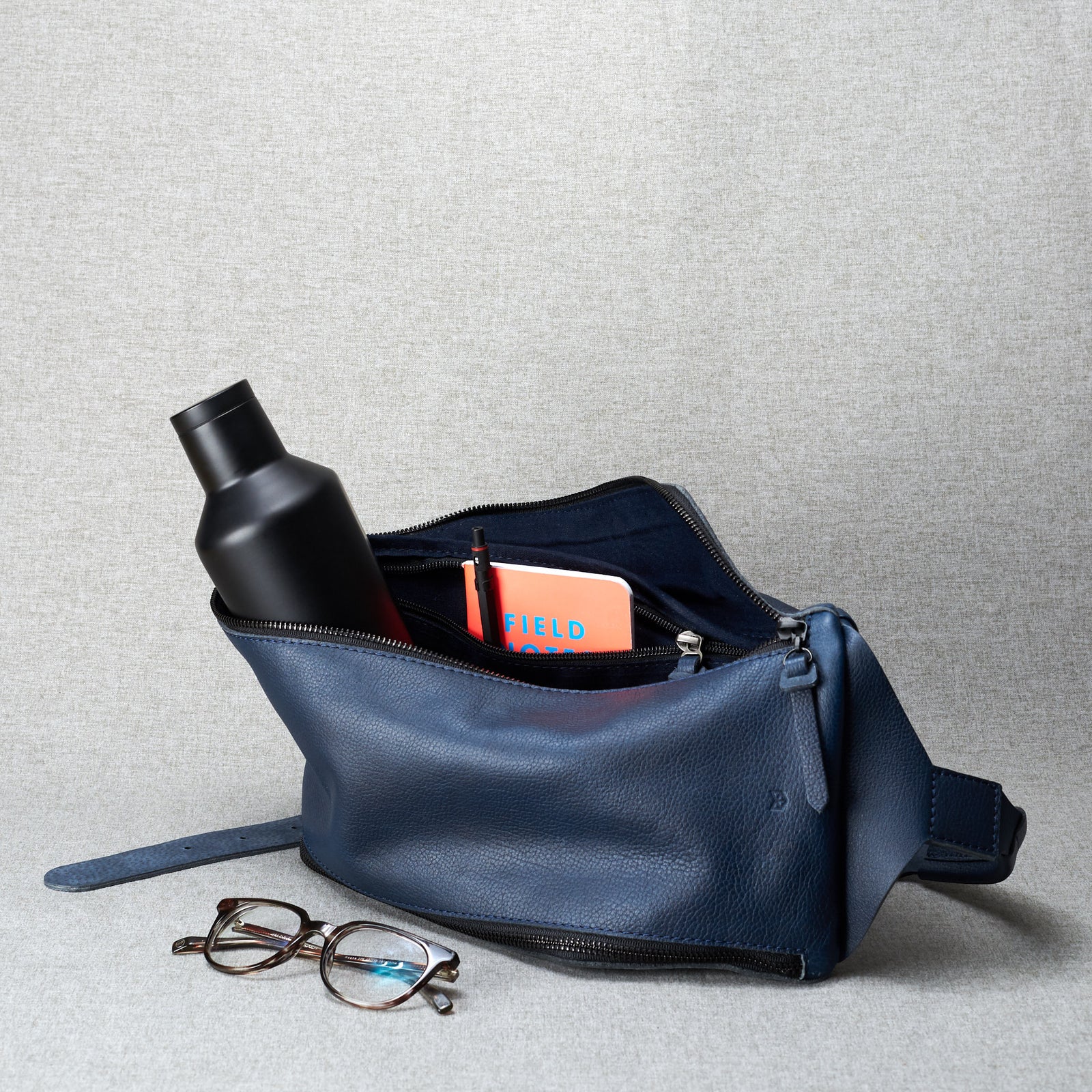 Blue linen. Fenek blue sling bag for men by Capra Leather. Single strap street bag.