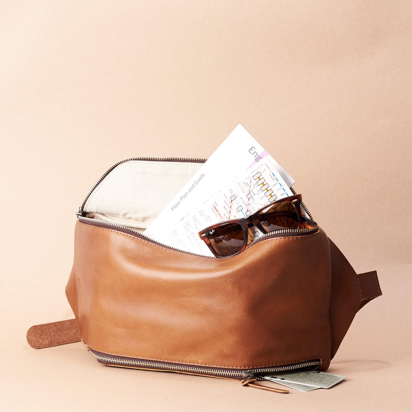 Tan Fenek sling bag backpack made by Capra Leather. Styling of over the shoulder bag in use.