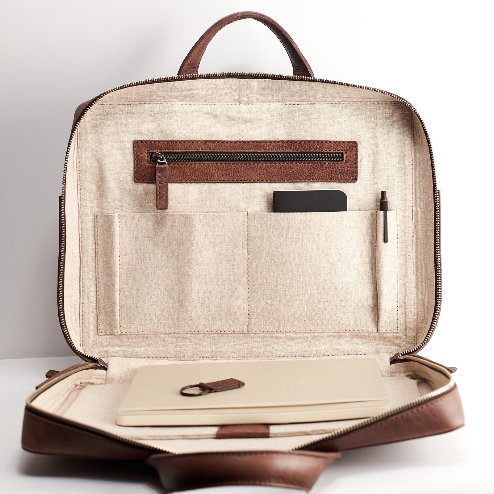 Interior pocket detail. Brown leather briefcase for men. Minimalist designer workbag