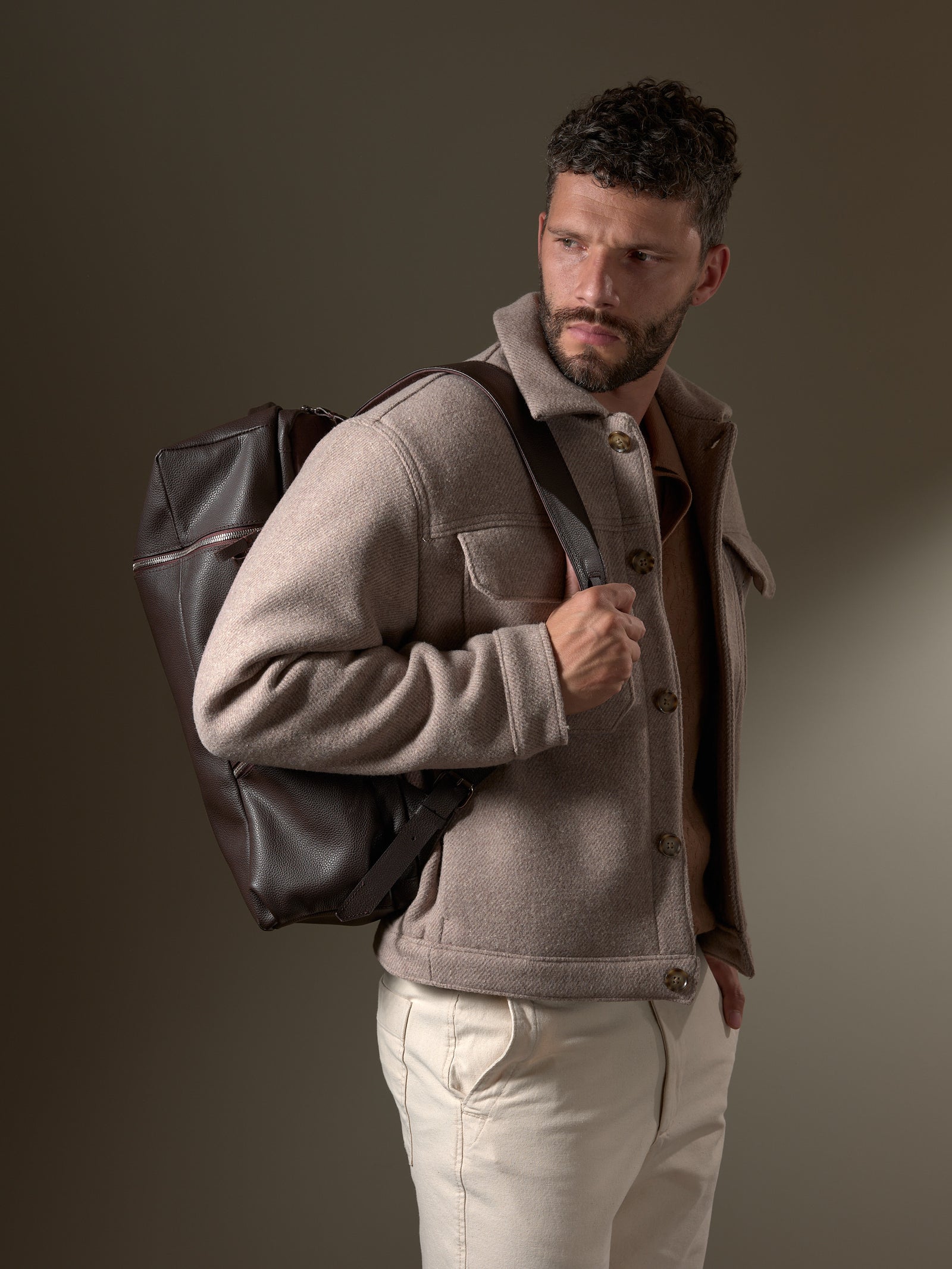 Stylish man wearing the Capra Leather Banteng; a premium leather backpack for men.