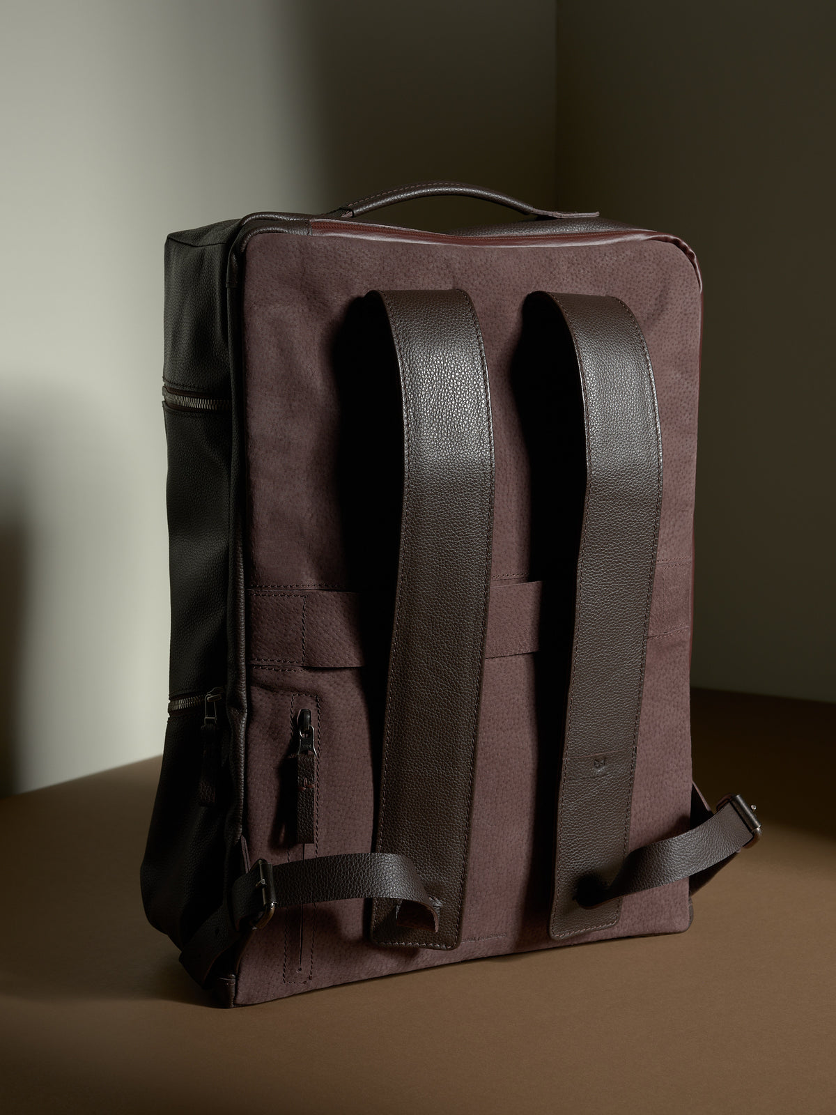 Back of the Banteng backpack showing the dark brown leather adjustable shoulder straps.
