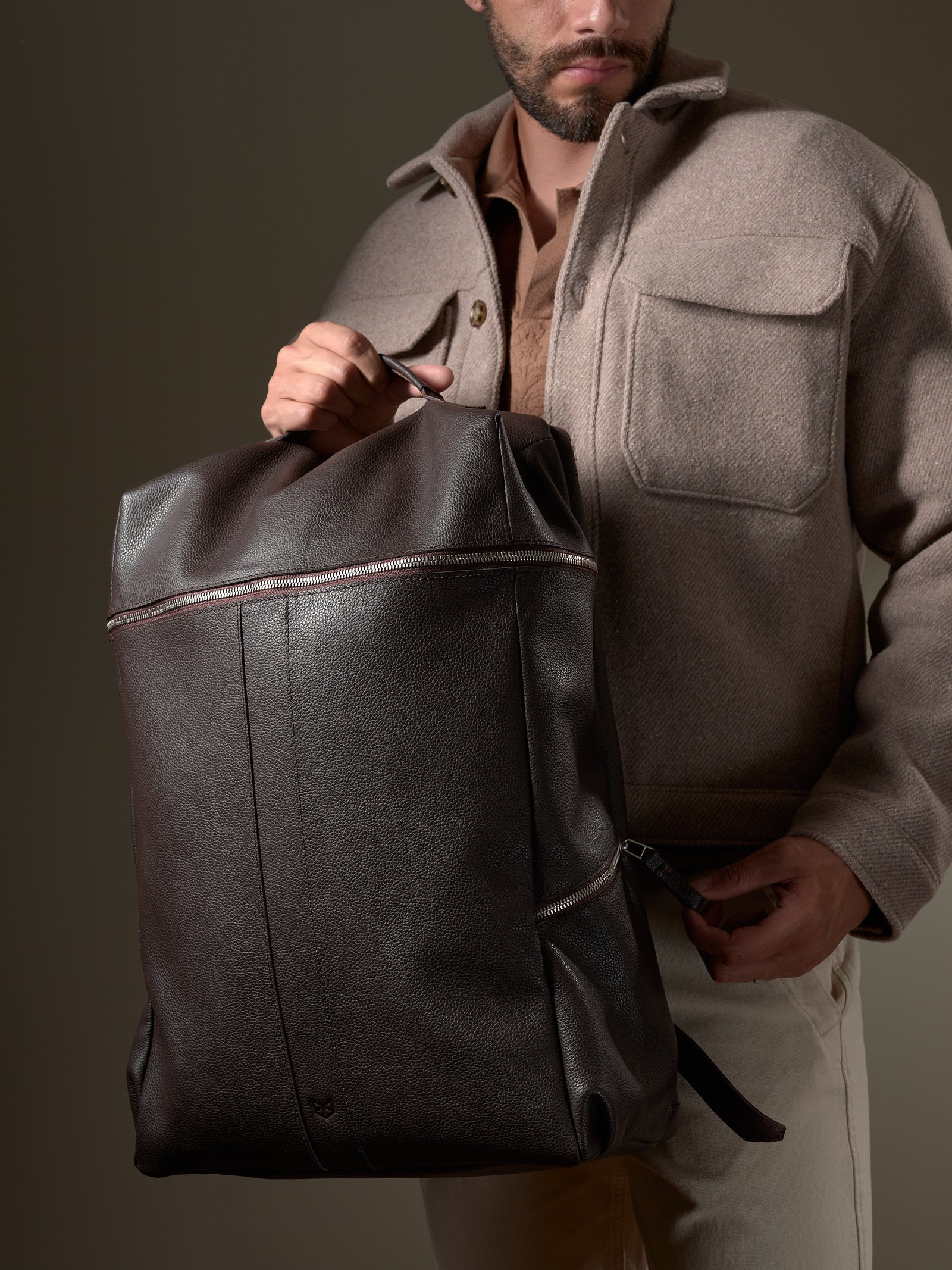 Stylish man wearing the Capra Leather Banteng; a premium leather backpack for men.