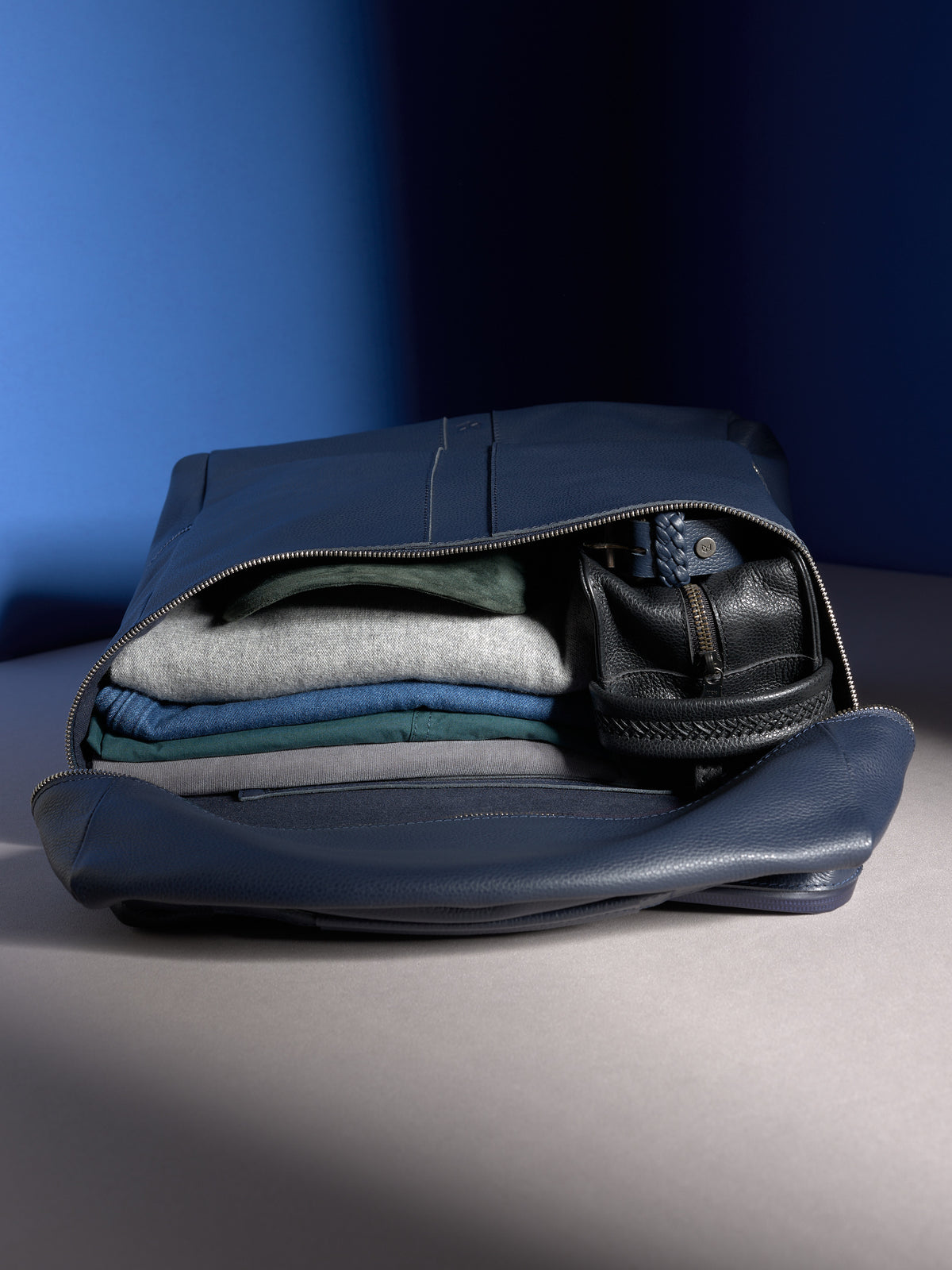 The spacious main compartment of the navy Banteng backpack, neatly packed with clothes for a weekend trip.
