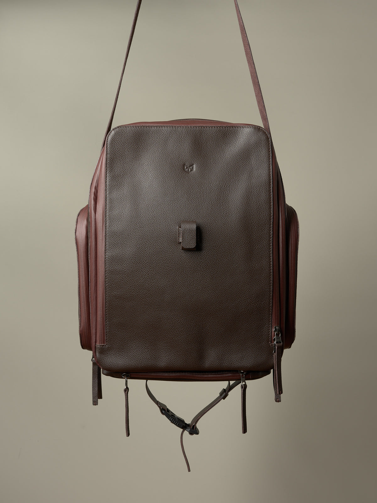 Rich brown and burgundy Capra Leather bike rack bag, showing its full-front profile and pannier straps.