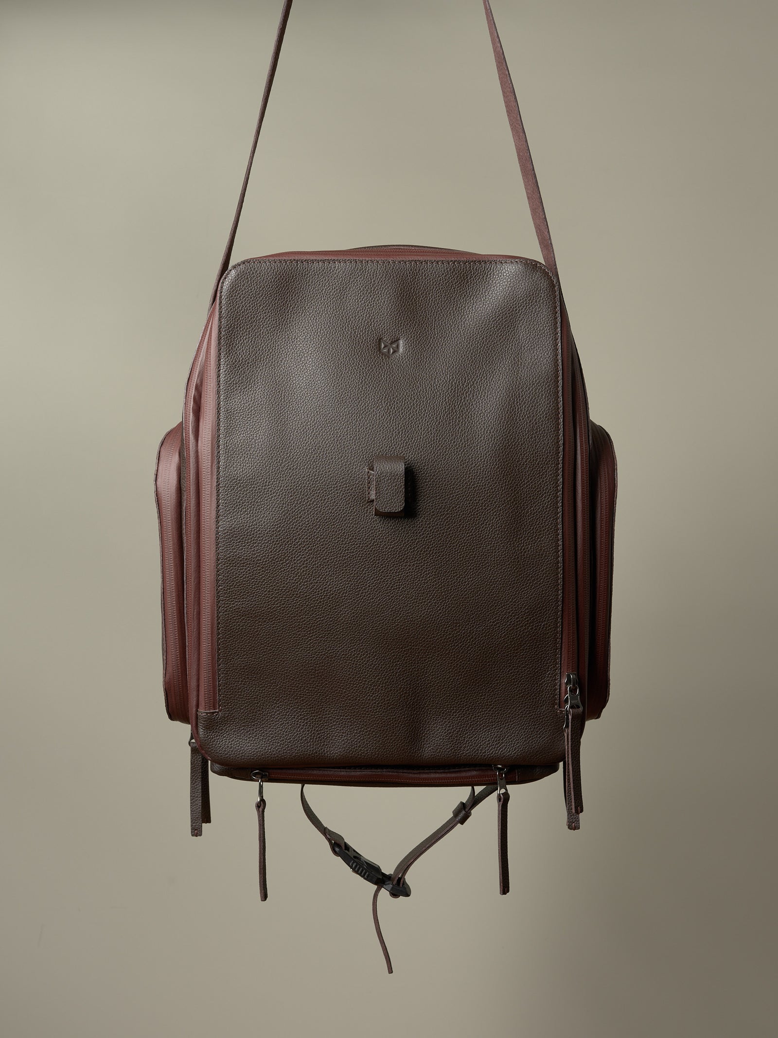 Rich brown and burgundy Capra Leather bike rack bag, showing its full-front profile and pannier straps.