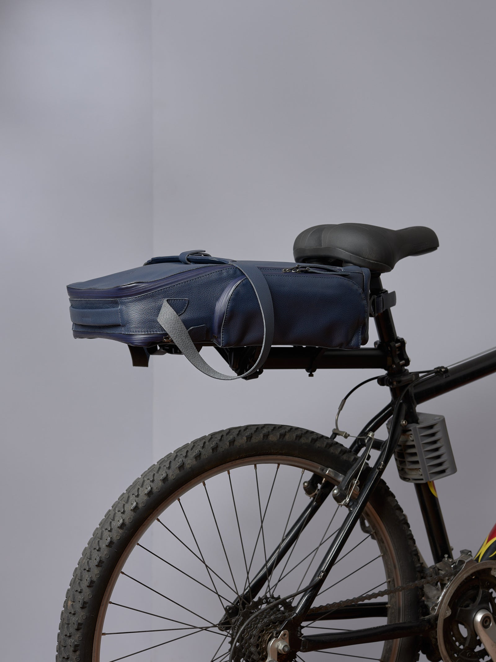 Rich brown and burgundy Capra Leather bike rack bag, showing its full-front profile and pannier straps.