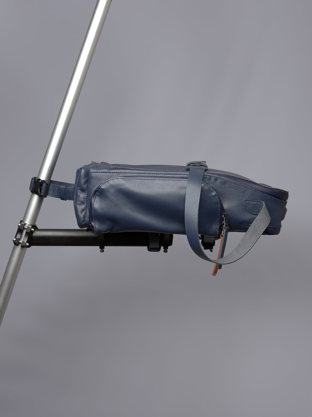 Blue leather Capra Leather bike bag securely mounted horizontally on a bicycle frame/rack.