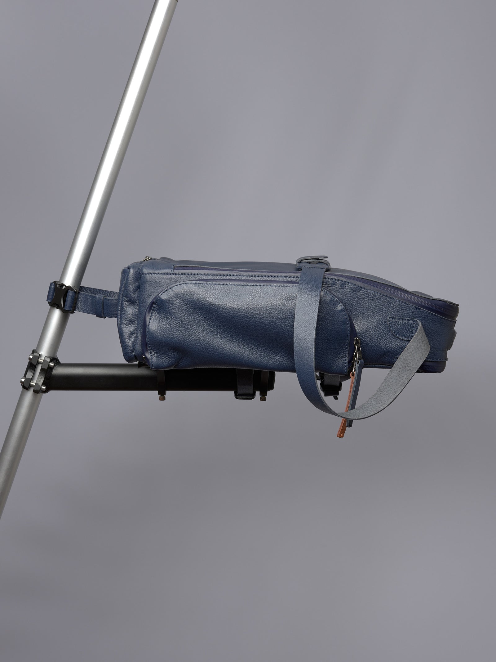 Blue leather Capra Leather bike bag securely mounted horizontally on a bicycle frame/rack.