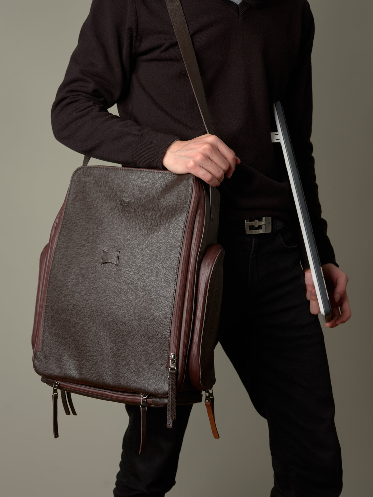 Man carrying the brown leather Capra Leather bike rack bag as a stylish messenger, a gift for men.