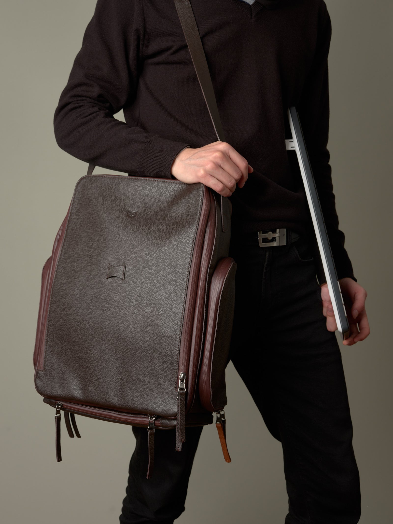 Man carrying the brown leather Capra Leather bike rack bag as a stylish messenger, a gift for men.