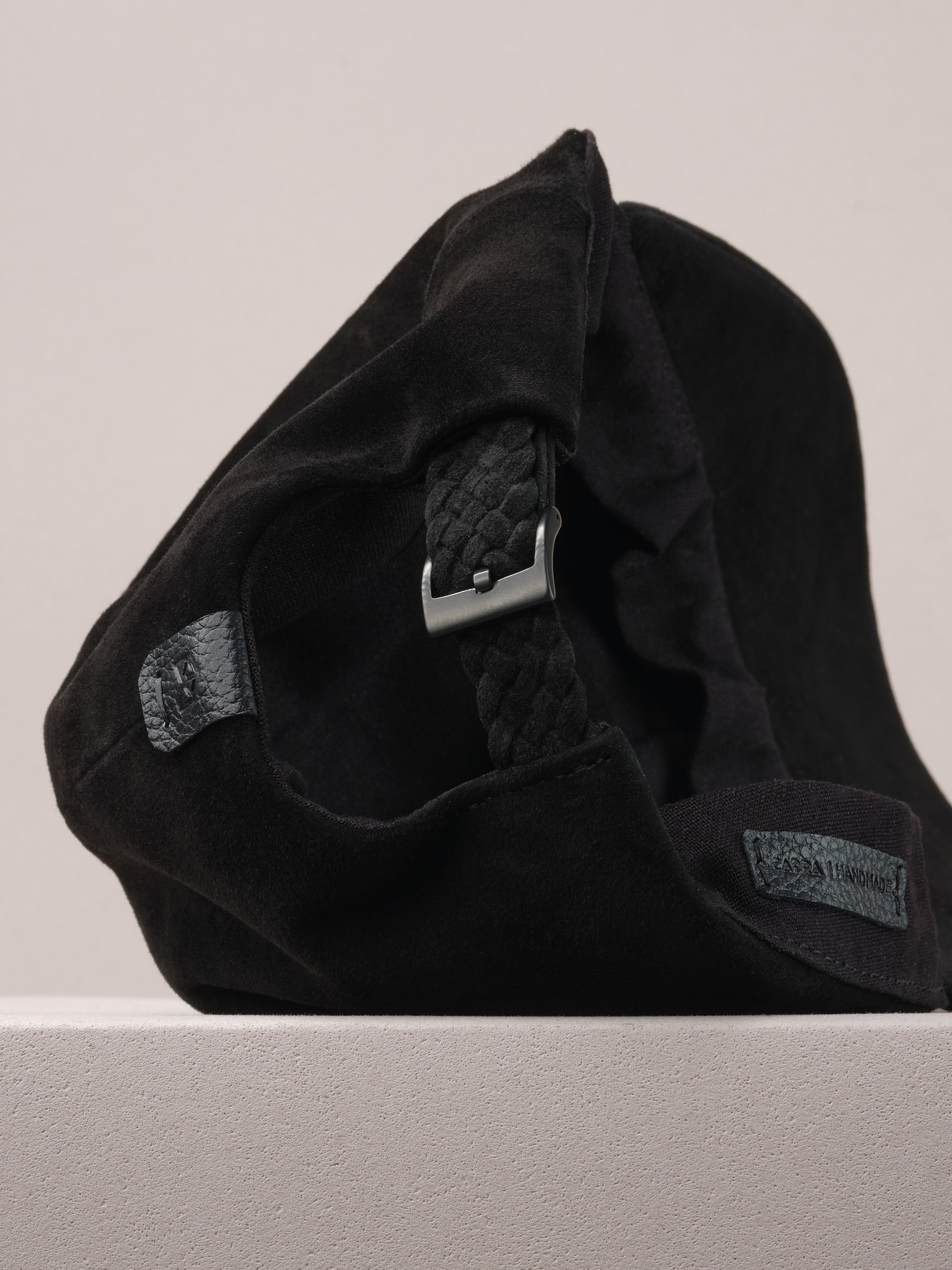 Capra Leather logo on the black suede baseball cap.