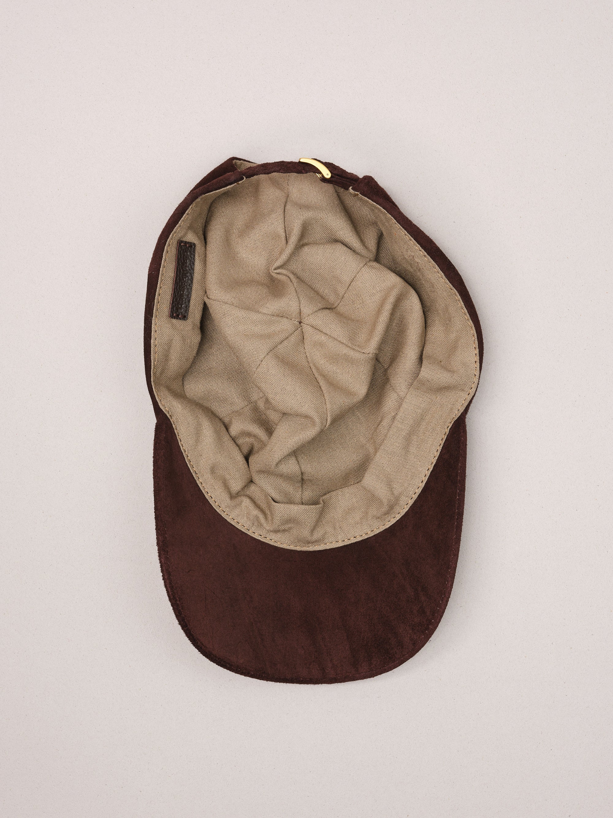 Soft natural linen lining inside the brown suede baseball cap.