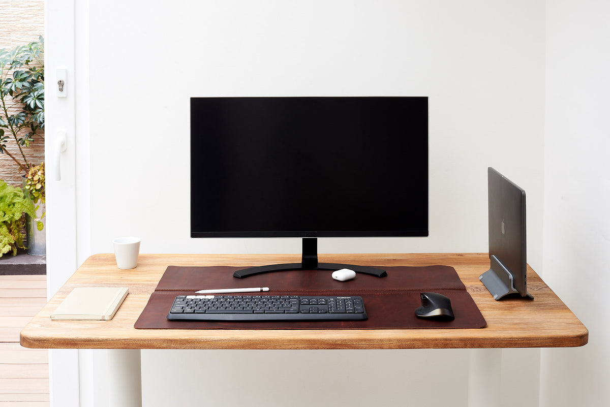 Smooth leather desk pad, perfect for any modern setup.