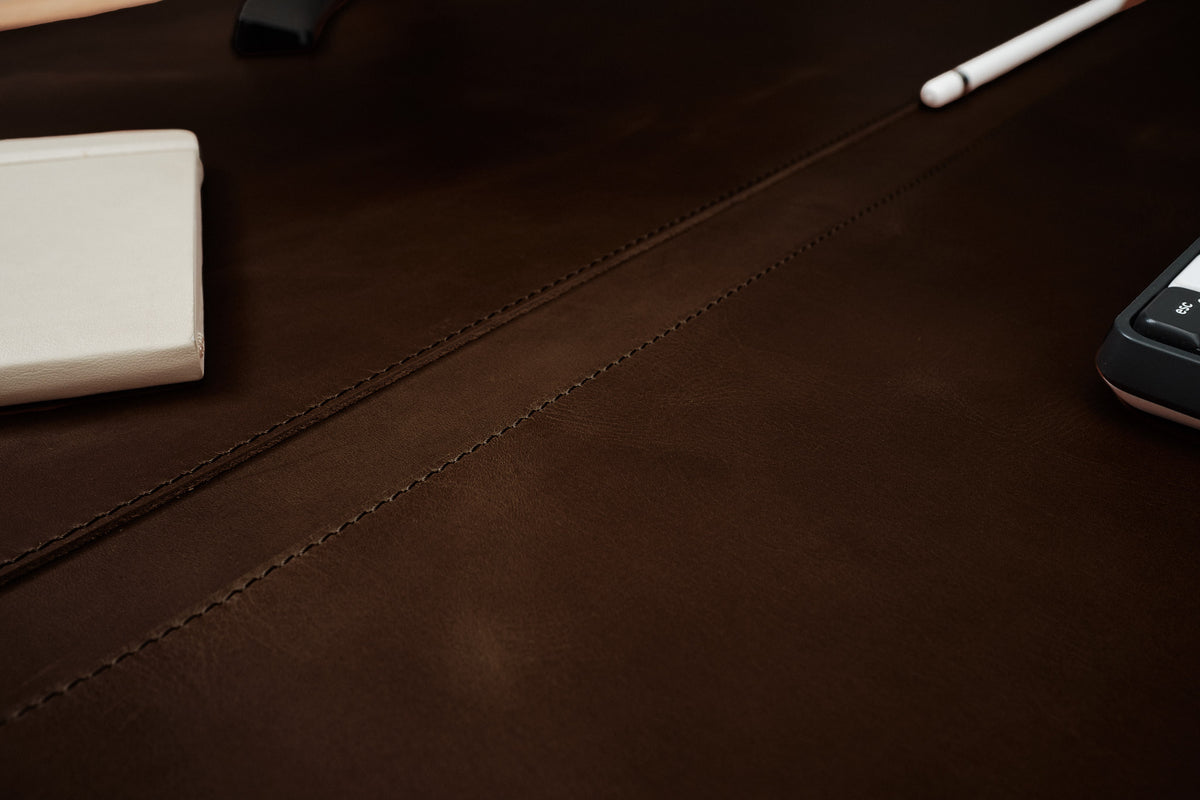 Leather desk pad with an optional pen slot for organization.