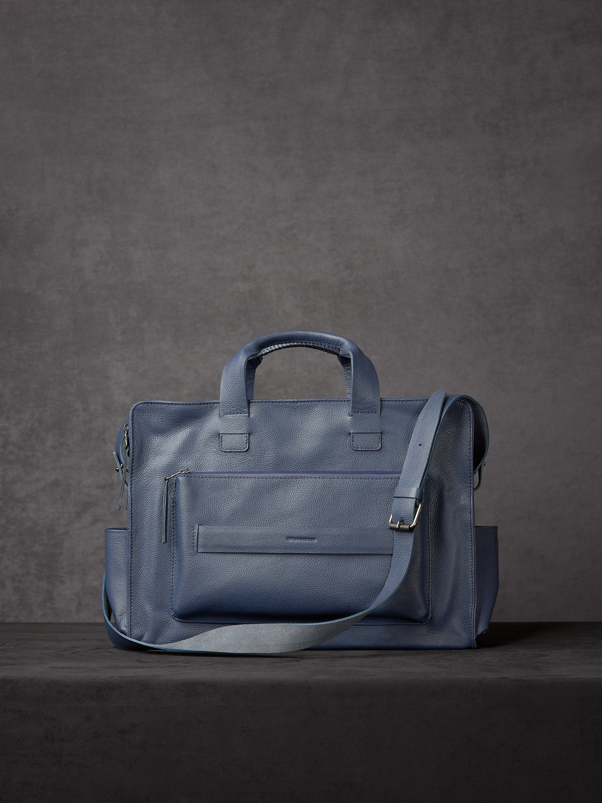 Navy blue full-grain leather briefcase with shoulder strap and handles by Capra Leather.
