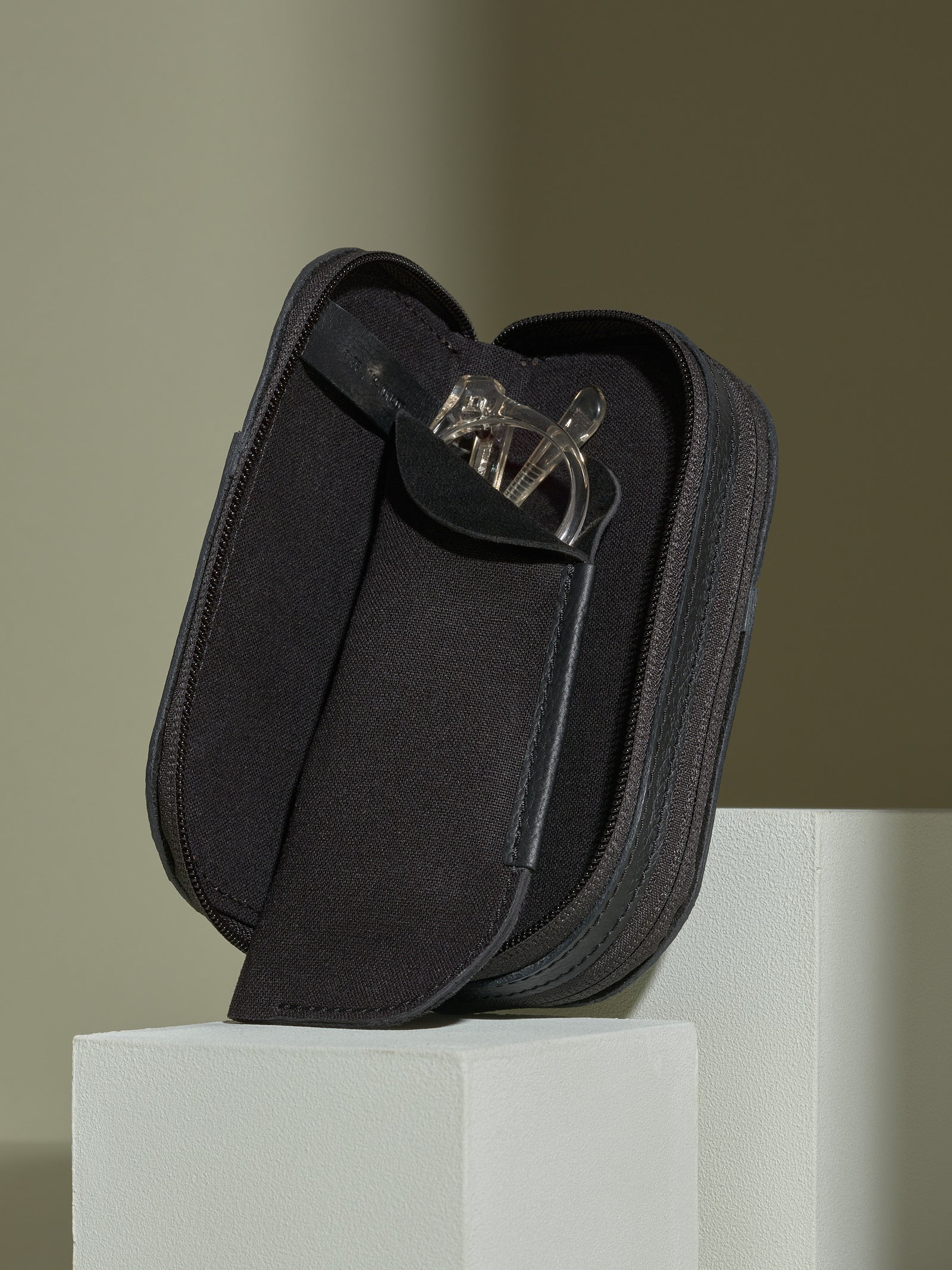Black leather double-glasses case open, revealing the removable soft pouch insert with clear reading glasses.