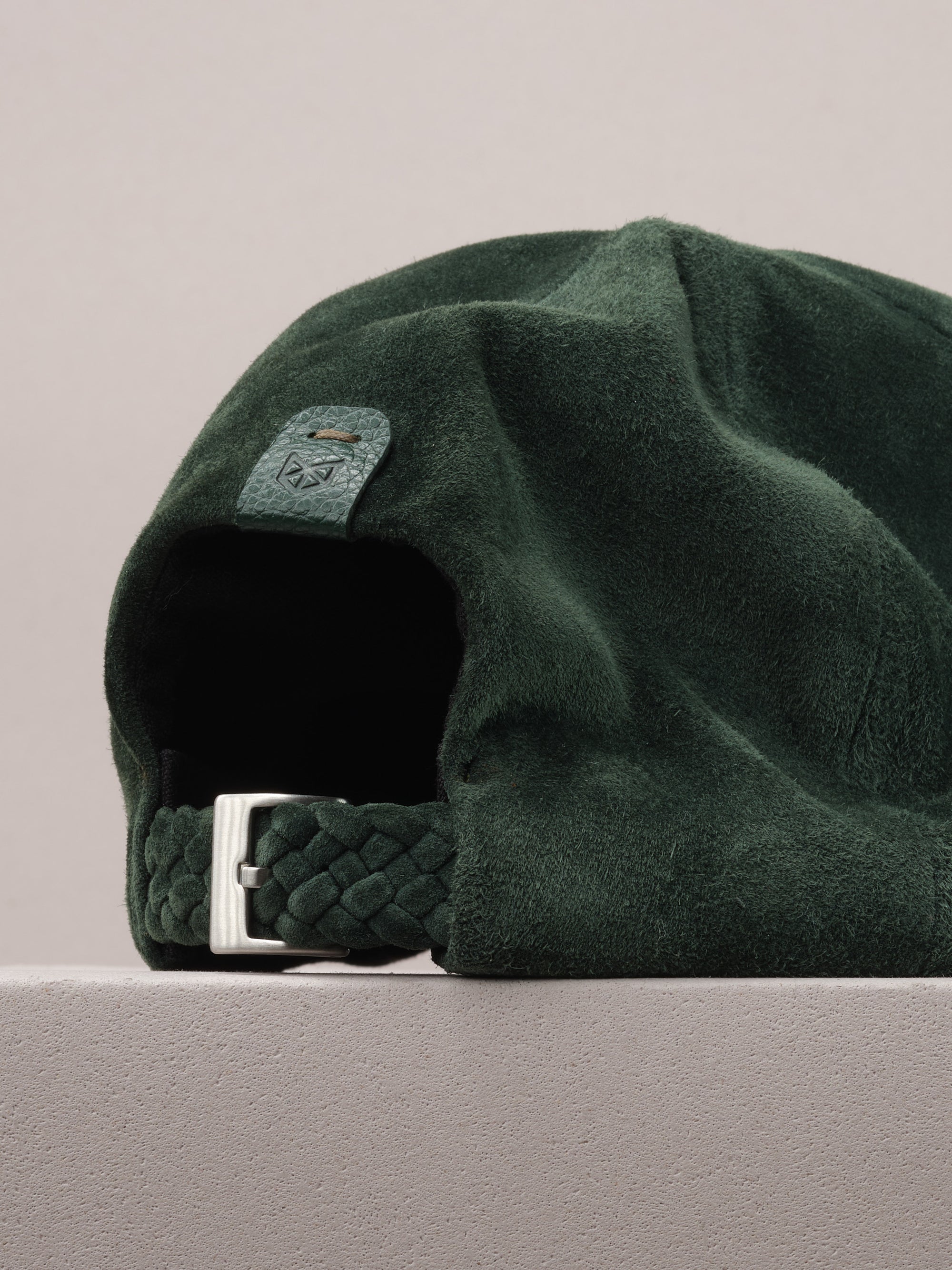 Capra Leather logo on the green suede baseball cap.