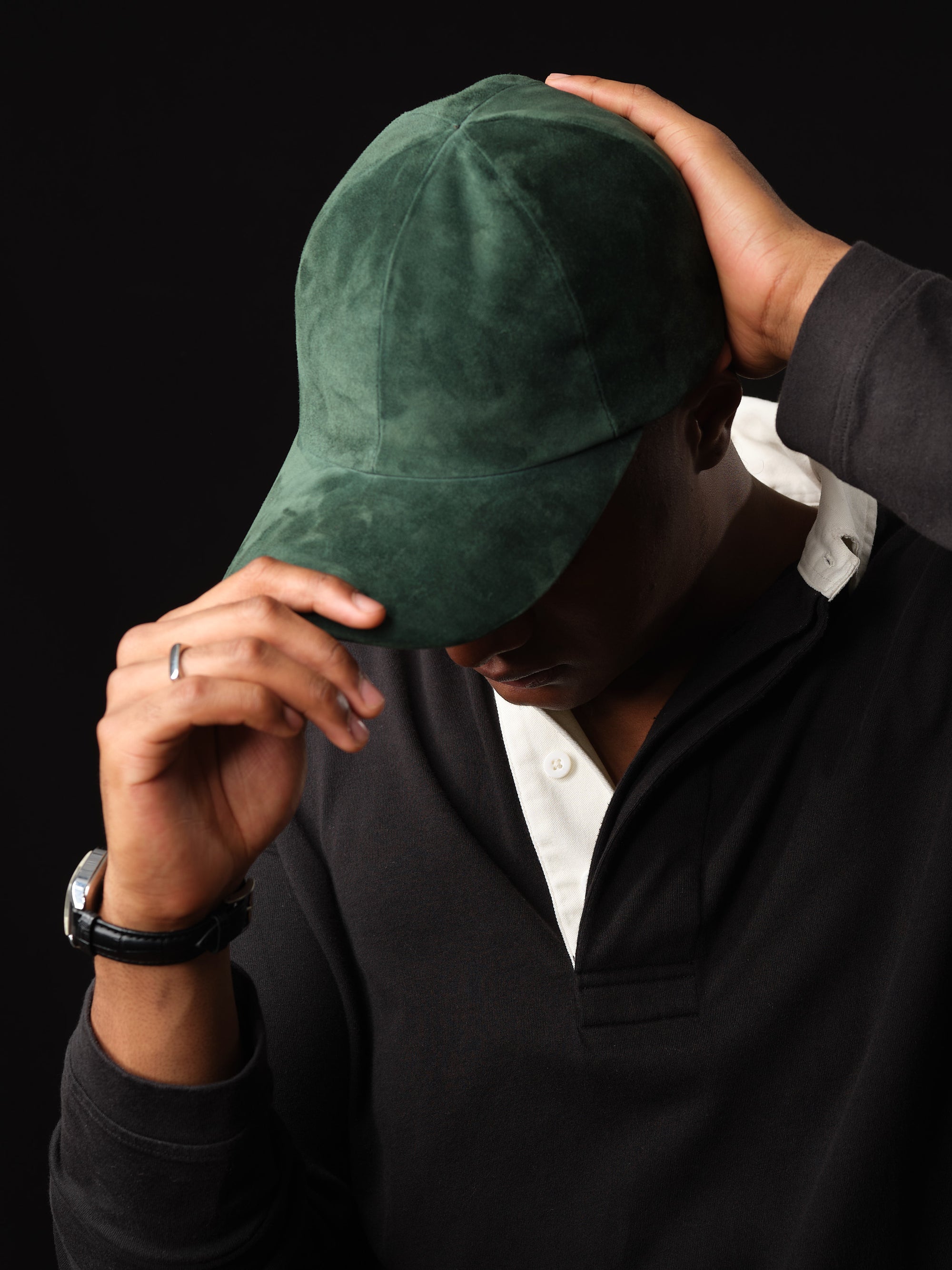 Man wearing a green suede baseball cap.