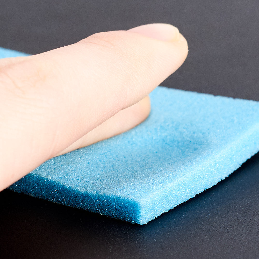 A finger pressing into memory foam, which shapes to the body and springs back