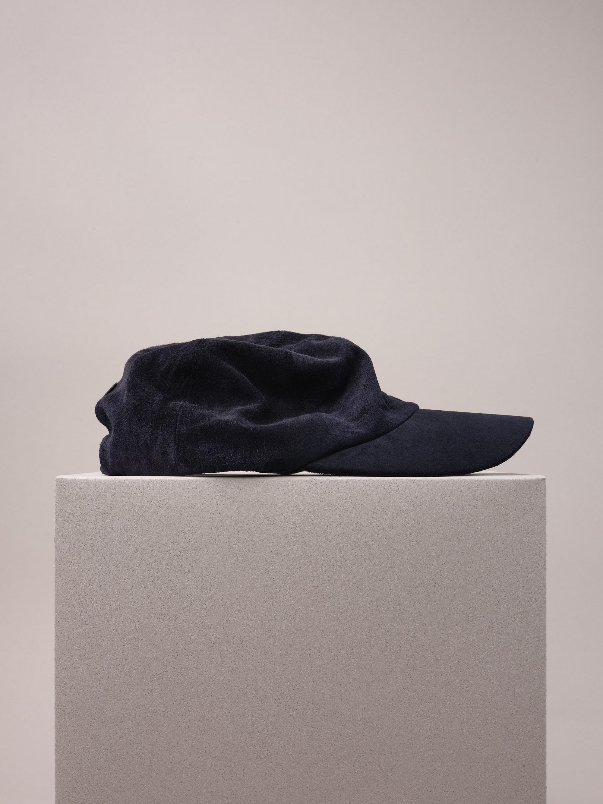 Luxurious navy calf suede baseball cap, soft and durable.