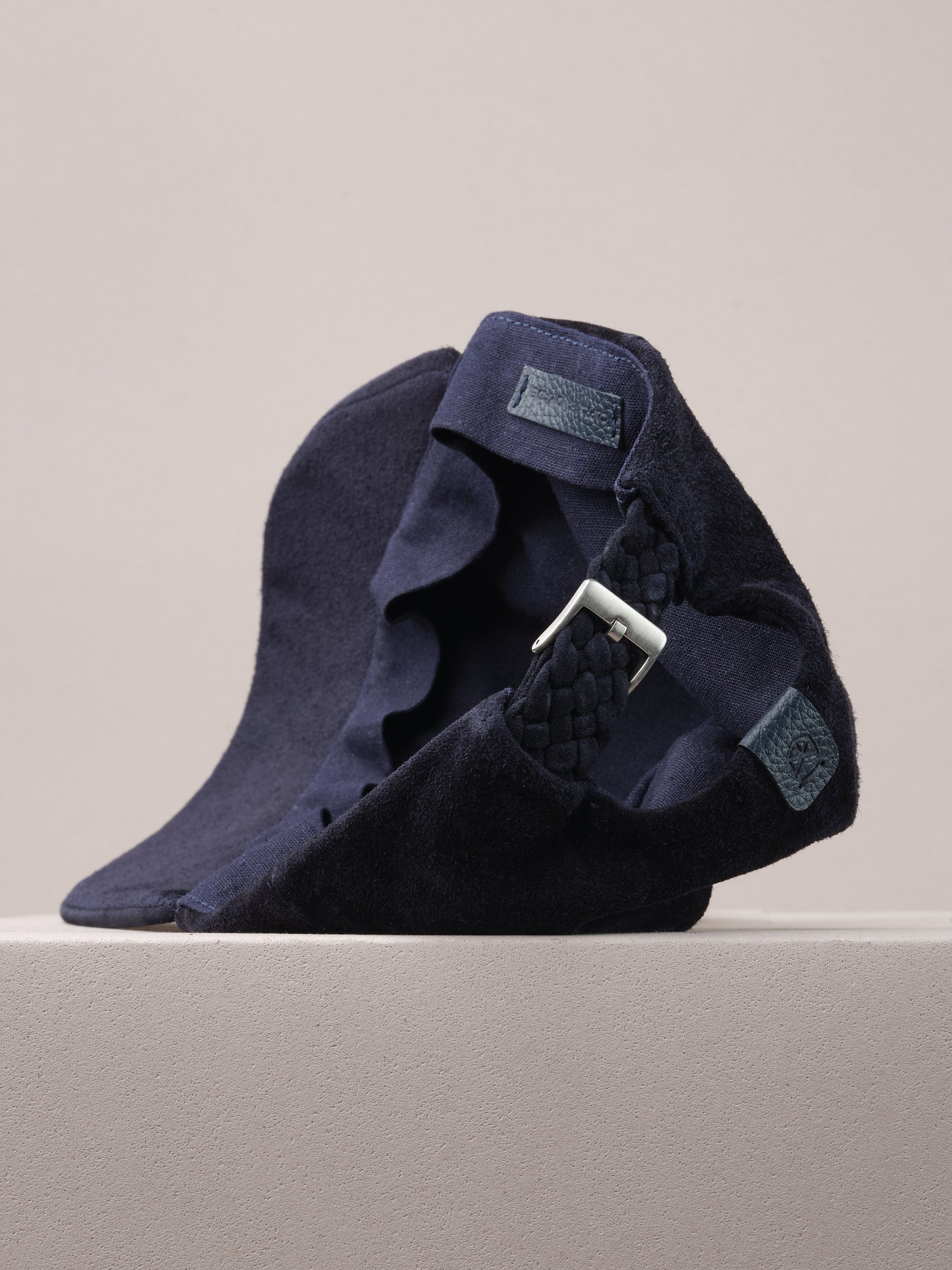 Capra Leather logo on the navy suede baseball cap.