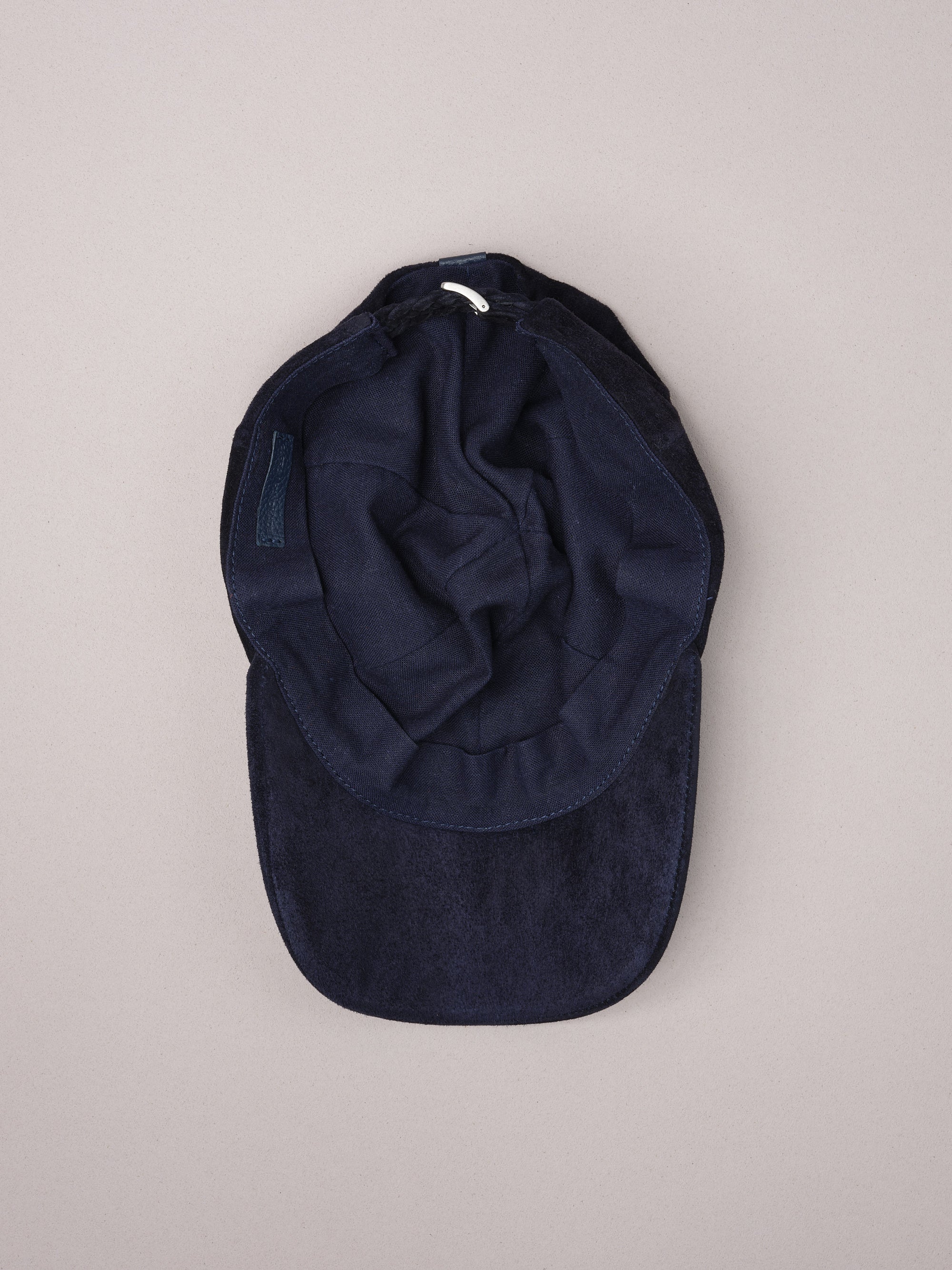 Soft natural linen lining inside the navy suede baseball cap.