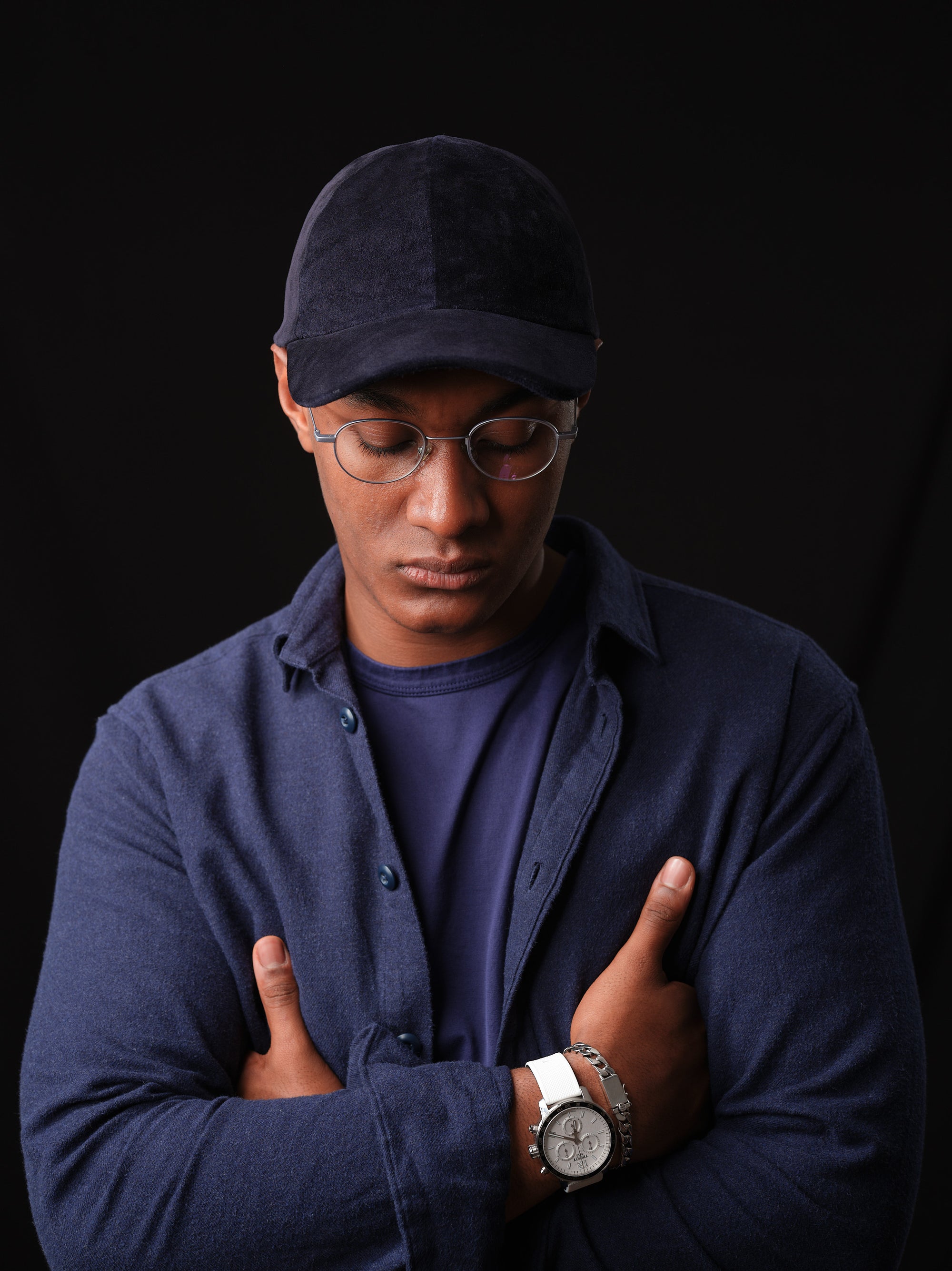 Athletic model wearing a navy suede baseball cap, handcrafted by Capra Leather