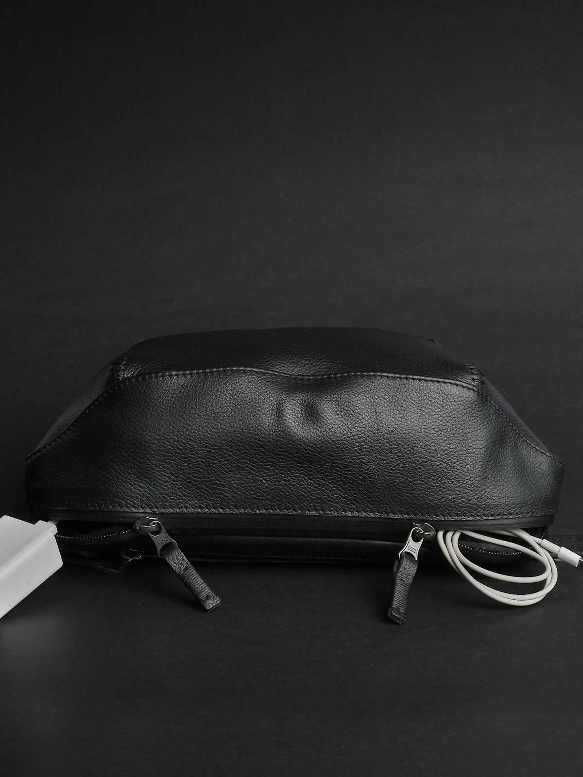 Kissing water-resistant zippers. Small Sling Bag Black by Capra Leather