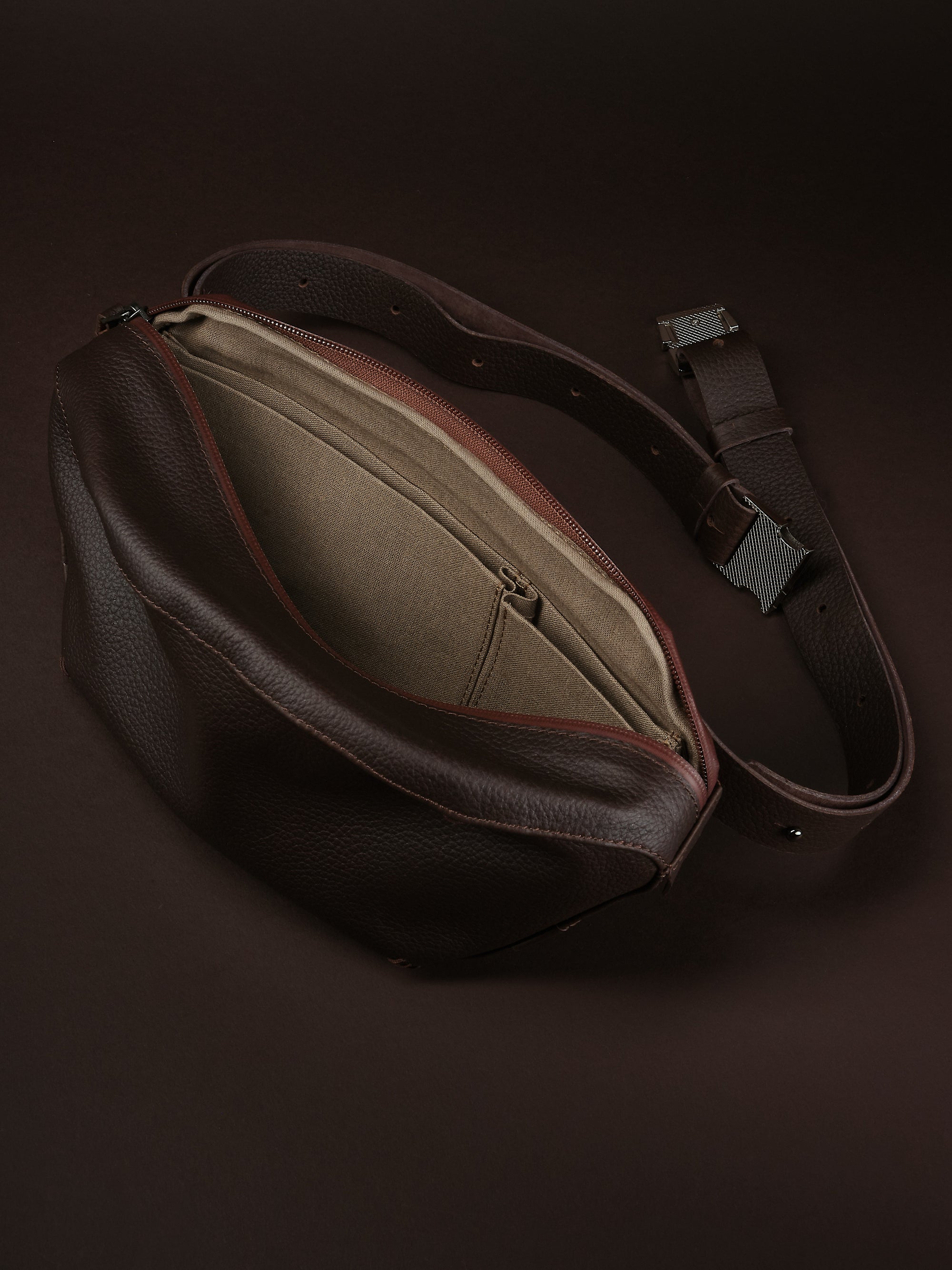 Divider pockets for essentials. Sling Bag for Men Dark Brown by Capra Leather