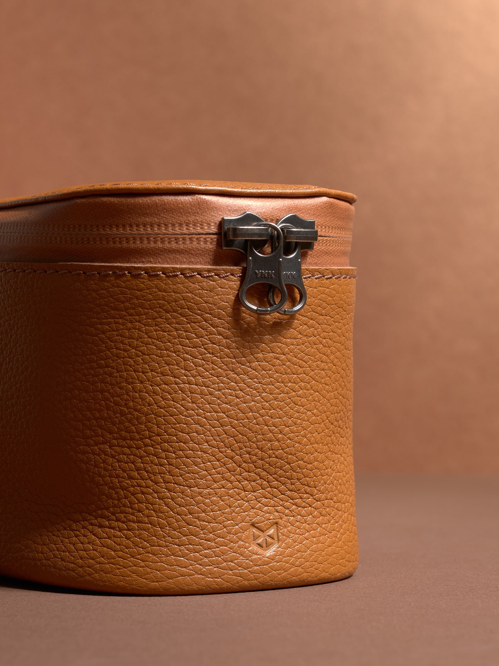Close-up of the durable YKK zipper and pebbled tan Capra Leather texture.