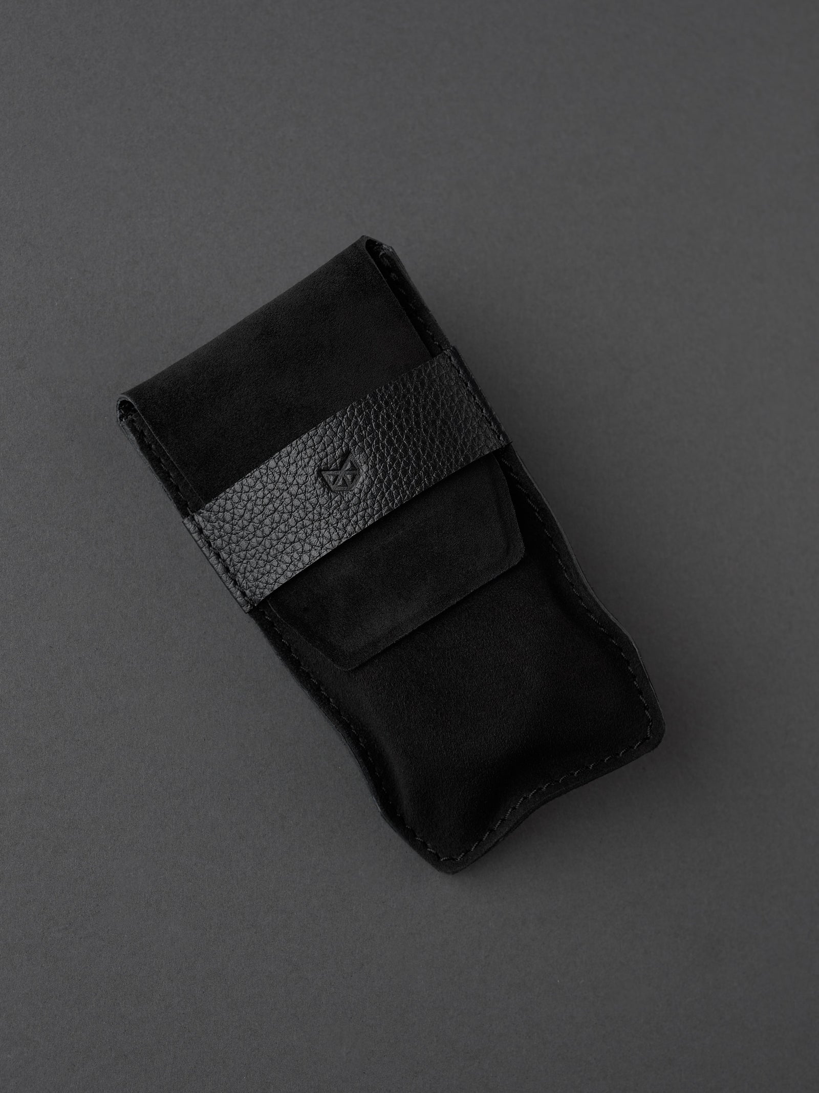 Capra Leather black suede watch pouch with a distinct leather band. Made in leather by Capra Leather.