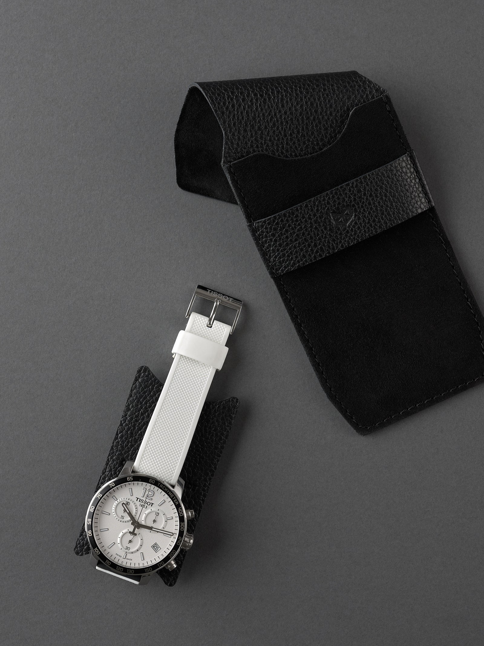 Capra Leather black suede watch pouch with a distinct leather band. Made in leather by Capra Leather.