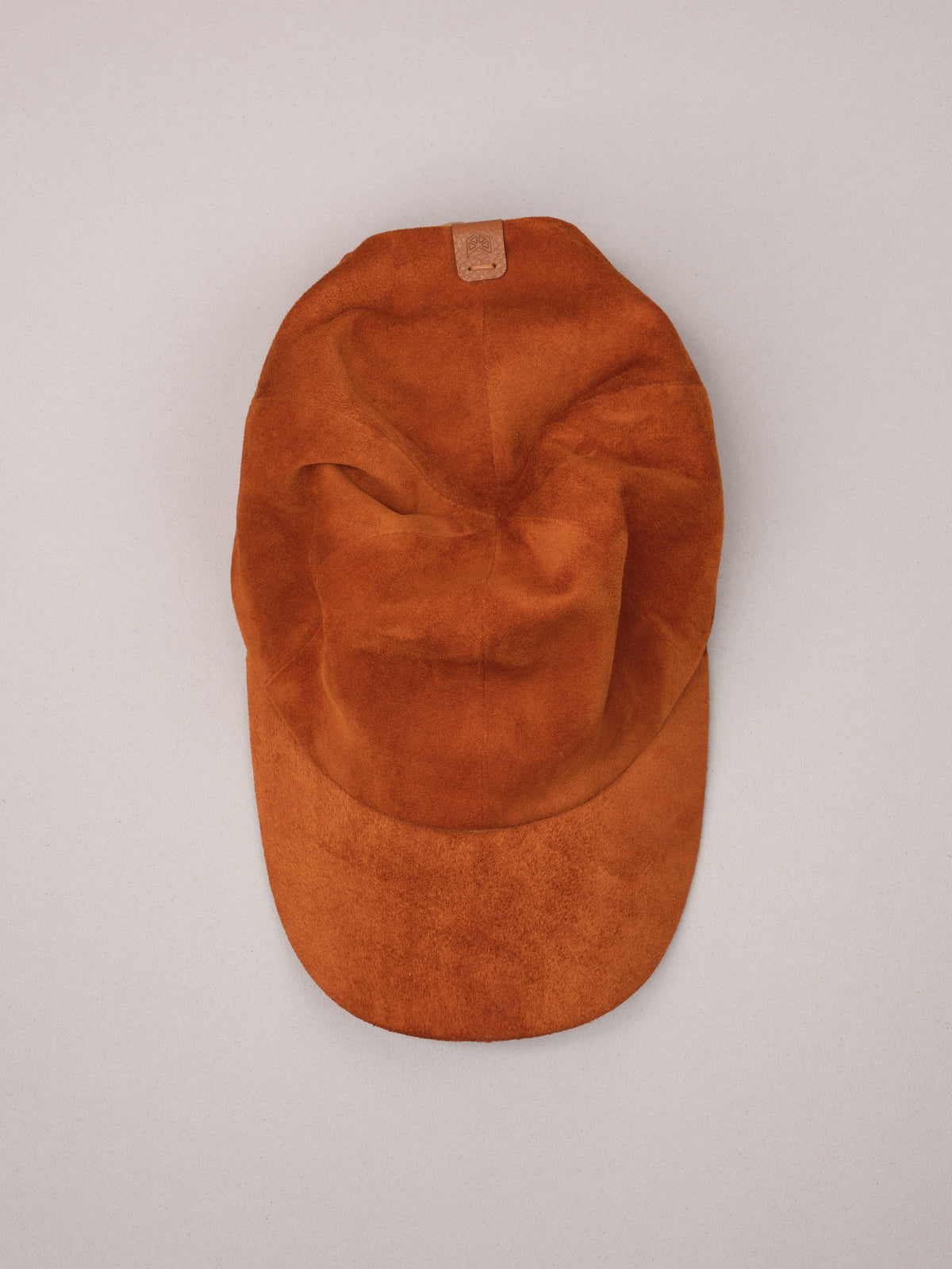 Handmade tan suede baseball cap.